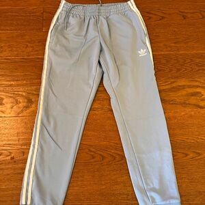 Adidas Women's Sky Blue Joggers with White Stripes
